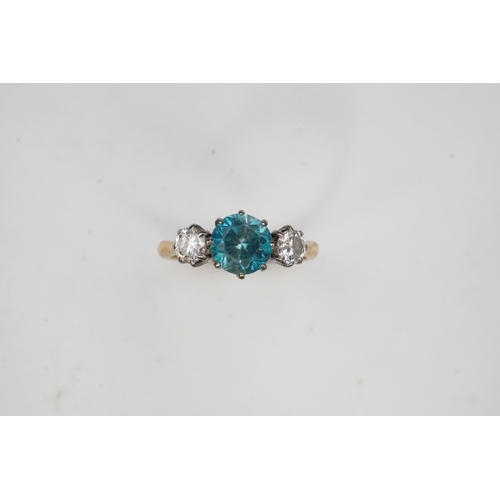 400 - A zircon and diamond ring, claw-set with a brilliant-cut blue zircon, between shoulders set with bri... 