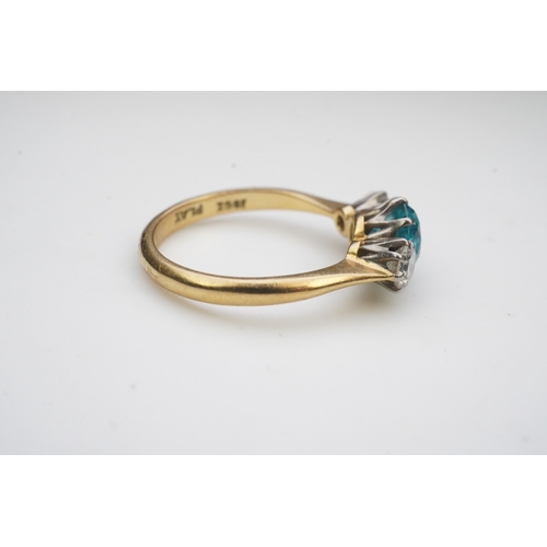 400 - A zircon and diamond ring, claw-set with a brilliant-cut blue zircon, between shoulders set with bri... 