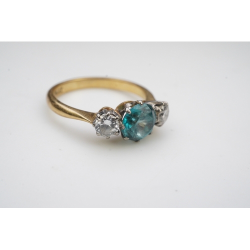 400 - A zircon and diamond ring, claw-set with a brilliant-cut blue zircon, between shoulders set with bri... 