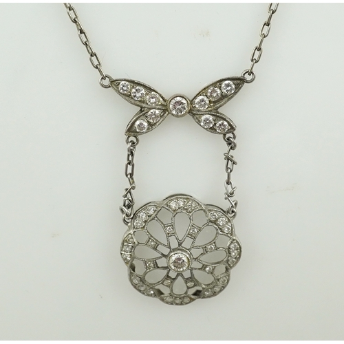 402 - A diamond pendant necklace, of Edwardian inspiration, designed as a bow suspending an openwork flora... 