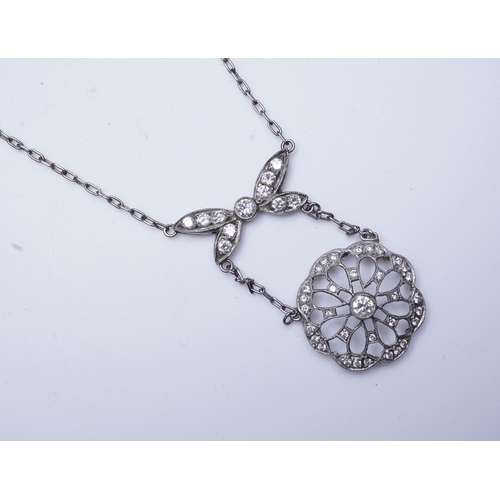 402 - A diamond pendant necklace, of Edwardian inspiration, designed as a bow suspending an openwork flora... 