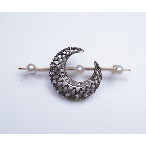 403 - An Edwardian pearl and diamond brooch, early 20th century, designed as a crescent moon set with cush... 