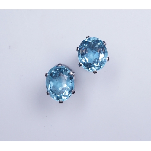 405 - A pair of aquamarine stud earrings, each claw-set with an oval aquamarine, length 10mm each, post fi... 