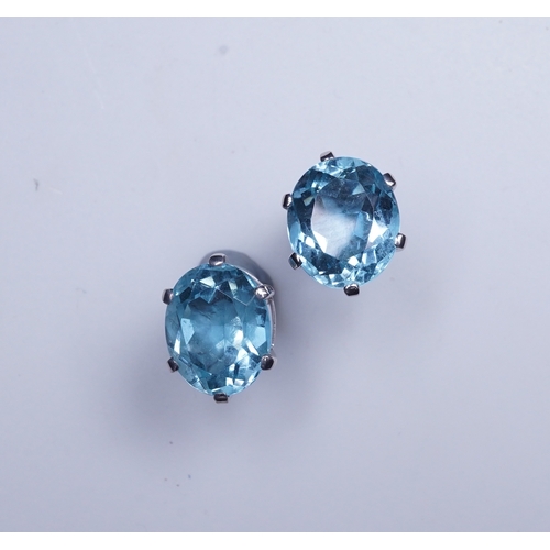 405 - A pair of aquamarine stud earrings, each claw-set with an oval aquamarine, length 10mm each, post fi... 