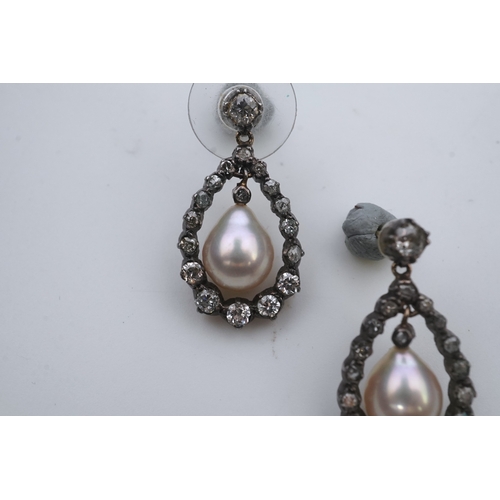 411 - A pair of cultured pearl and diamond earrings, each designed as a pear-shaped drop, suspending a cul... 