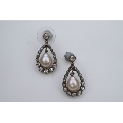 411 - A pair of cultured pearl and diamond earrings, each designed as a pear-shaped drop, suspending a cul... 