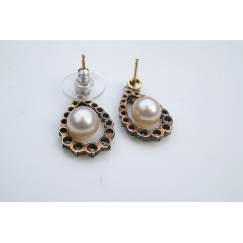 411 - A pair of cultured pearl and diamond earrings, each designed as a pear-shaped drop, suspending a cul... 