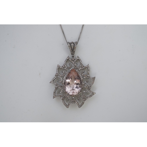 412 - A morganite and diamond pendant, set with a pear-shaped morganite weighing 8.80 carats, within a fol... 