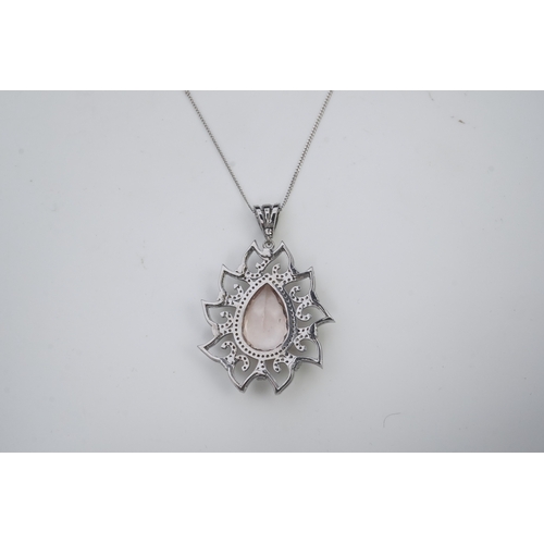 412 - A morganite and diamond pendant, set with a pear-shaped morganite weighing 8.80 carats, within a fol... 