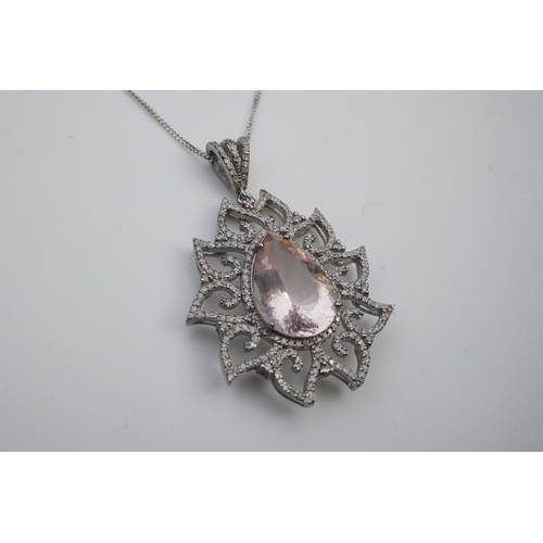 412 - A morganite and diamond pendant, set with a pear-shaped morganite weighing 8.80 carats, within a fol... 