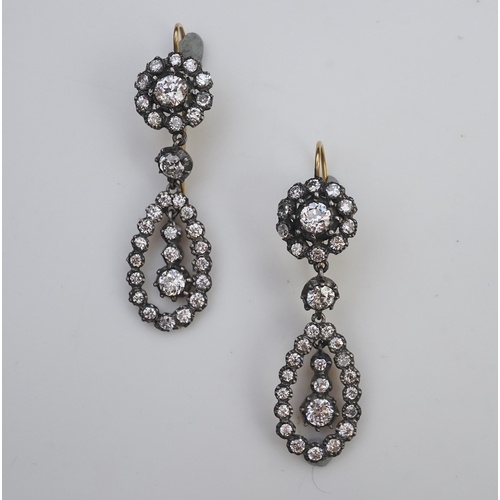 413 - A pair of diamond earrings, each of drop design, composed of a circular cluster suspending a pear-sh... 