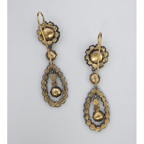 413 - A pair of diamond earrings, each of drop design, composed of a circular cluster suspending a pear-sh... 