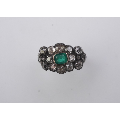 415 - A Georgian diamond and simulant emerald ring, circa 1800 of floral design, set with cushion-shaped d... 