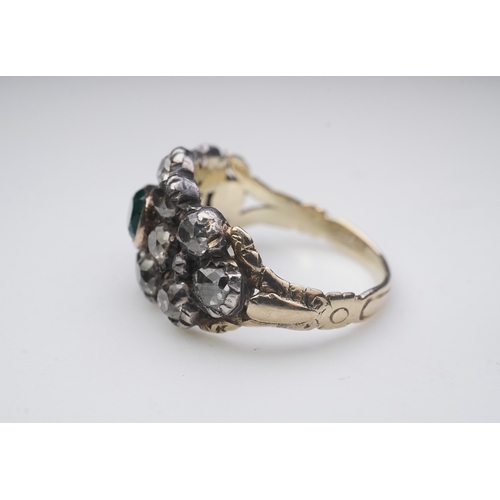 415 - A Georgian diamond and simulant emerald ring, circa 1800 of floral design, set with cushion-shaped d... 