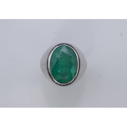 418 - An emerald signet ring, rubover set with an oval emerald measuring approximately 15.7mm x 10.9mm x 7... 