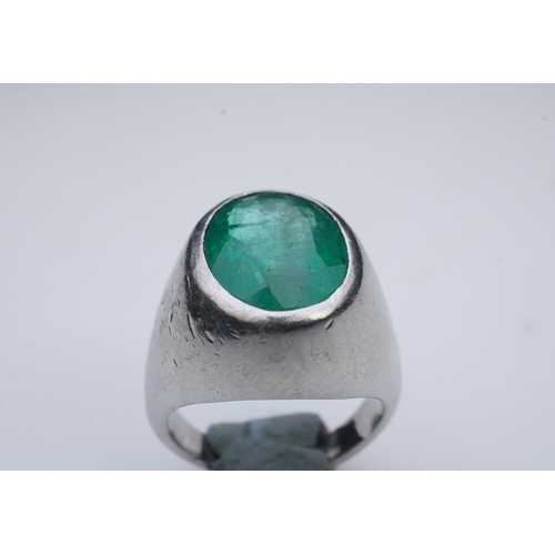 418 - An emerald signet ring, rubover set with an oval emerald measuring approximately 15.7mm x 10.9mm x 7... 