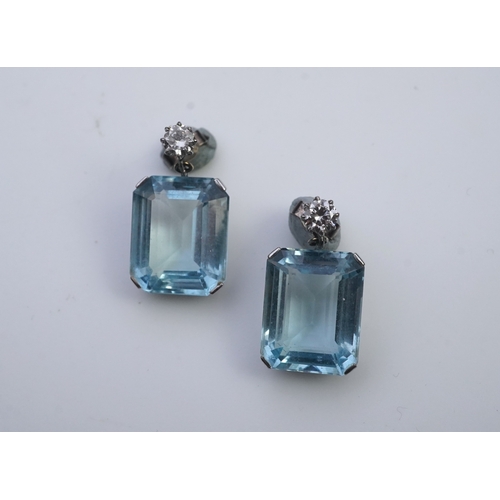 419 - A pair of aquamarine and diamond earrings, each set with a step-cut aquamarine, suspended from a bri... 