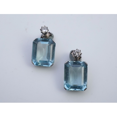 419 - A pair of aquamarine and diamond earrings, each set with a step-cut aquamarine, suspended from a bri... 