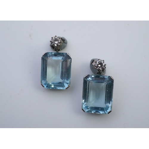 419 - A pair of aquamarine and diamond earrings, each set with a step-cut aquamarine, suspended from a bri... 