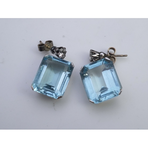 419 - A pair of aquamarine and diamond earrings, each set with a step-cut aquamarine, suspended from a bri... 