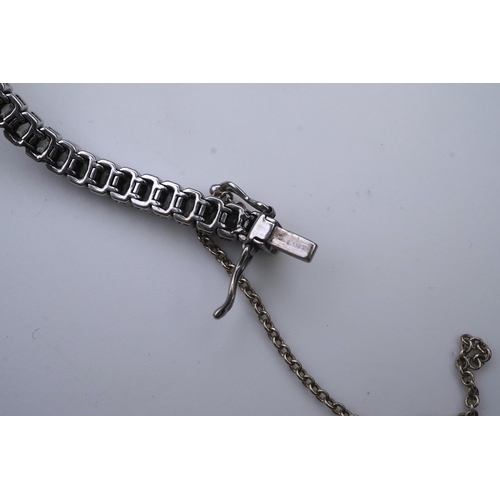 421 - A diamond bracelet, designed as a sequence of links set with step-cut diamonds, centring on a cross ... 