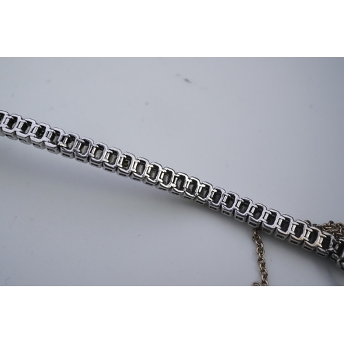 421 - A diamond bracelet, designed as a sequence of links set with step-cut diamonds, centring on a cross ... 