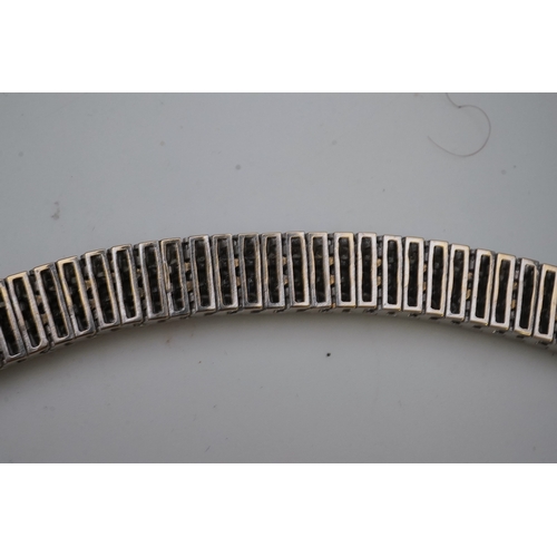 422 - A diamond bracelet, composed of links set with three rows of brilliant-cut diamonds totalling approx... 