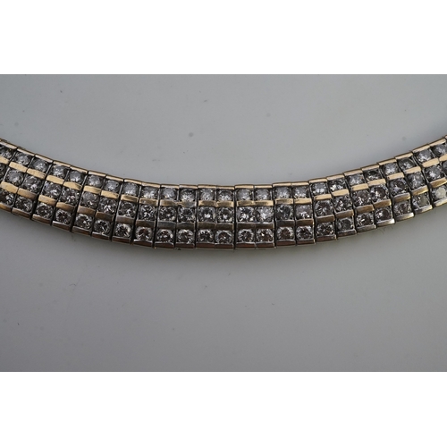 422 - A diamond bracelet, composed of links set with three rows of brilliant-cut diamonds totalling approx... 