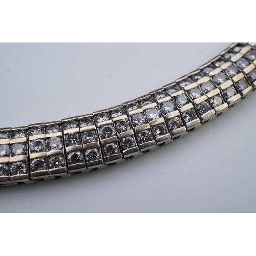 422 - A diamond bracelet, composed of links set with three rows of brilliant-cut diamonds totalling approx... 