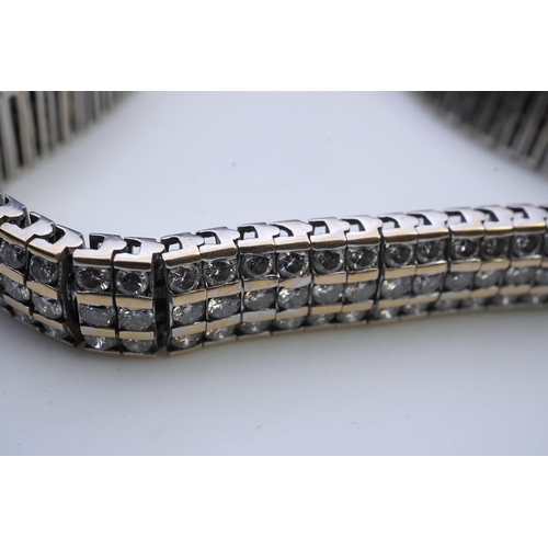 422 - A diamond bracelet, composed of links set with three rows of brilliant-cut diamonds totalling approx... 