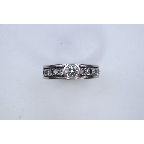 424 - A diamond eternity ring, centring on a circular-cut diamond weighing approximately 0.50 carats, to a... 