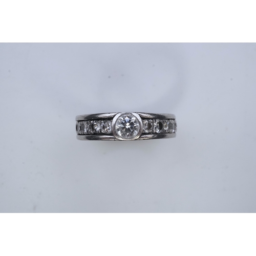 424 - A diamond eternity ring, centring on a circular-cut diamond weighing approximately 0.50 carats, to a... 