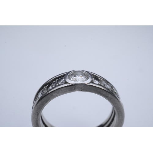 424 - A diamond eternity ring, centring on a circular-cut diamond weighing approximately 0.50 carats, to a... 