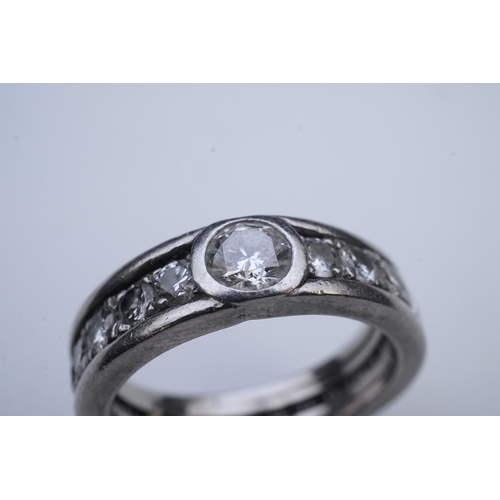 424 - A diamond eternity ring, centring on a circular-cut diamond weighing approximately 0.50 carats, to a... 