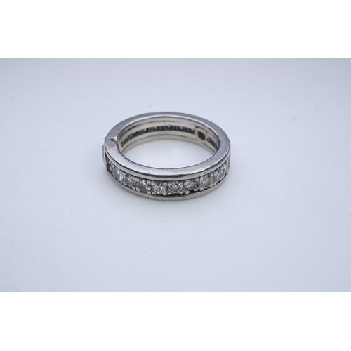 424 - A diamond eternity ring, centring on a circular-cut diamond weighing approximately 0.50 carats, to a... 