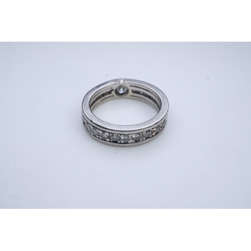 424 - A diamond eternity ring, centring on a circular-cut diamond weighing approximately 0.50 carats, to a... 