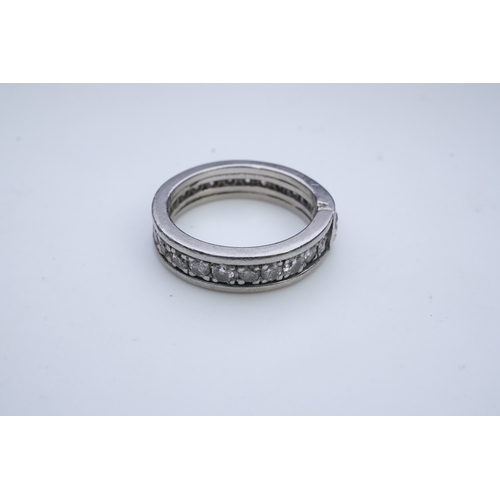 424 - A diamond eternity ring, centring on a circular-cut diamond weighing approximately 0.50 carats, to a... 