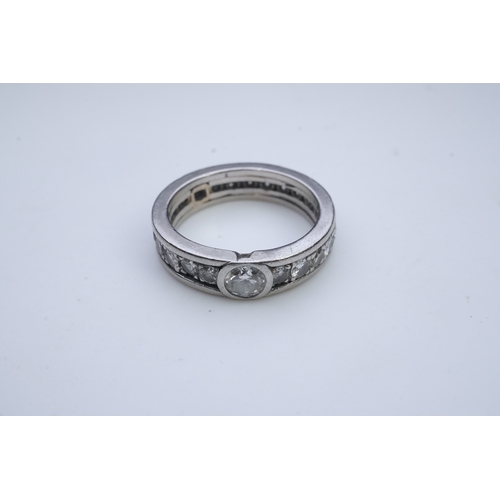 424 - A diamond eternity ring, centring on a circular-cut diamond weighing approximately 0.50 carats, to a... 