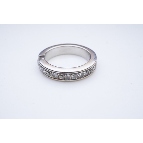 426 - A diamond eternity ring, centring on a tension-set circular-cut diamond weighing approximately 0.25 ... 