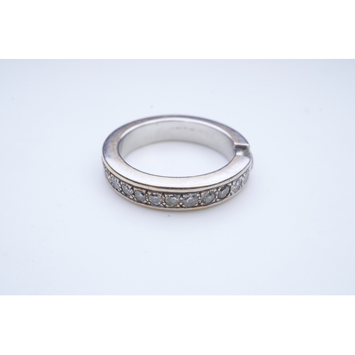 426 - A diamond eternity ring, centring on a tension-set circular-cut diamond weighing approximately 0.25 ... 