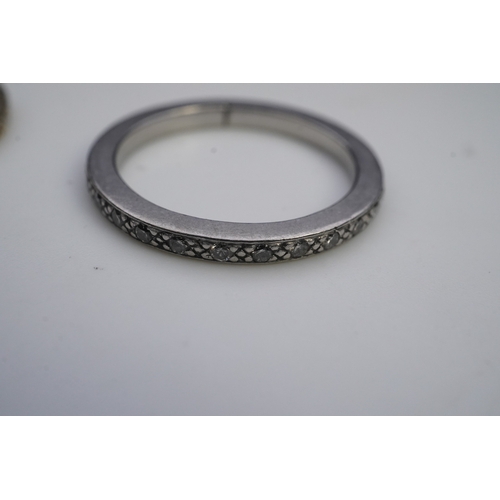 427 - A pair of diamond eternity rings, each set a continuous band of brilliant-cut diamonds, mounted in y... 