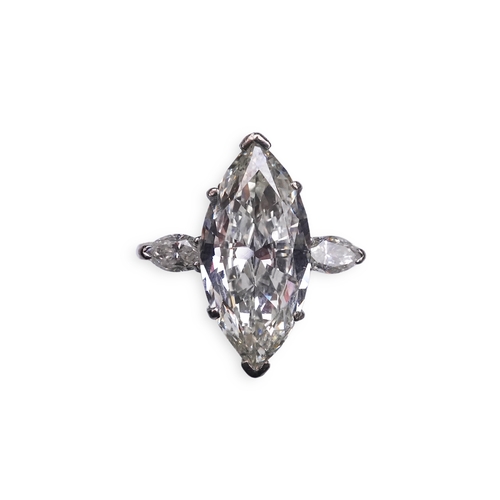 431 - An impressive diamond ring, set with a marquise-shaped diamond weighing 4.79 carats, to shoulders se... 