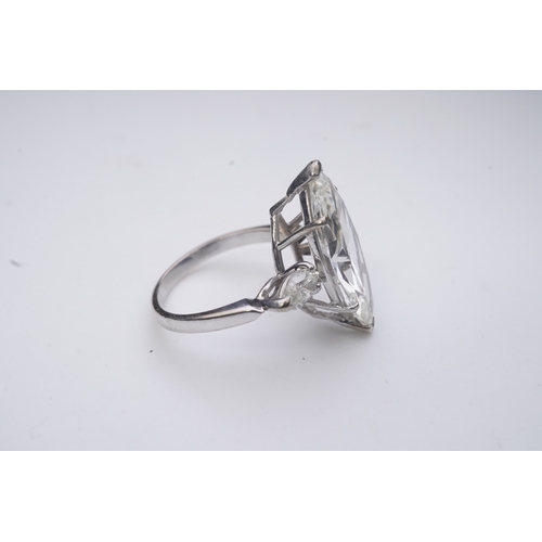 431 - An impressive diamond ring, set with a marquise-shaped diamond weighing 4.79 carats, to shoulders se... 