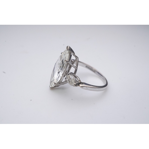 431 - An impressive diamond ring, set with a marquise-shaped diamond weighing 4.79 carats, to shoulders se... 