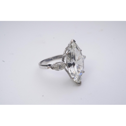 431 - An impressive diamond ring, set with a marquise-shaped diamond weighing 4.79 carats, to shoulders se... 