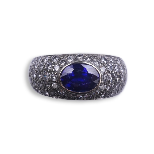 432 - A sapphire and diamond ring, of bombé design, collet-set with an oval sapphire, to shoulders pavé-se... 