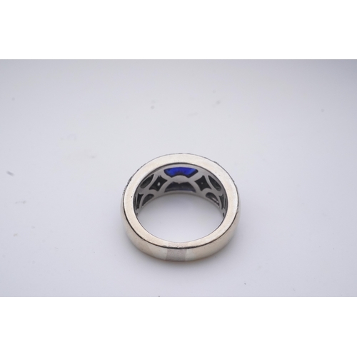 432 - A sapphire and diamond ring, of bombé design, collet-set with an oval sapphire, to shoulders pavé-se... 