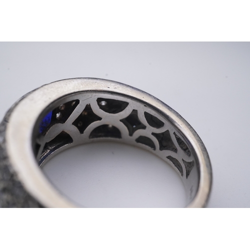 432 - A sapphire and diamond ring, of bombé design, collet-set with an oval sapphire, to shoulders pavé-se... 