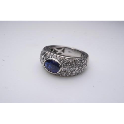 432 - A sapphire and diamond ring, of bombé design, collet-set with an oval sapphire, to shoulders pavé-se... 