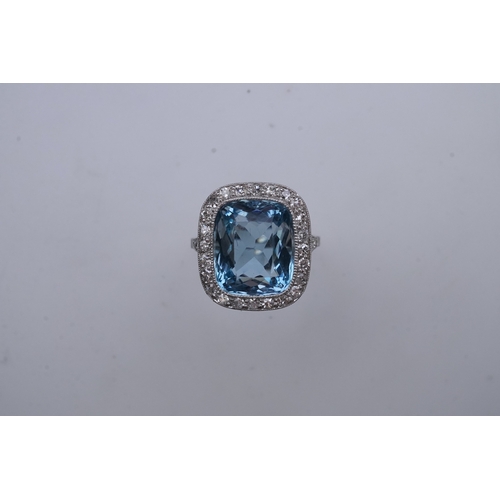 436 - An attractive aquamarine and diamond ring, of cluster design, set with a cushion-shaped aquamarine, ... 